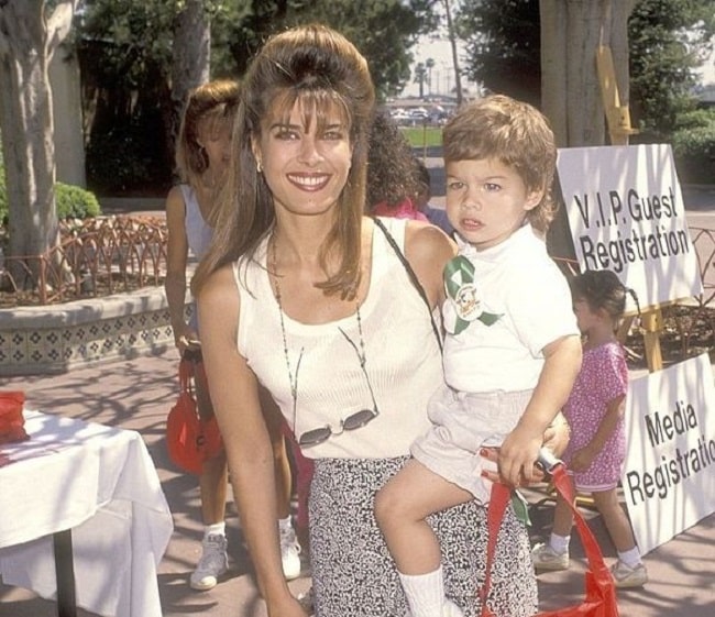 Kristina Alfonso wearing white tank top and carrying son Gino Macauley wearing white t-shirt and white half pant attend 'Happy Birthday, Camp Snoop' 