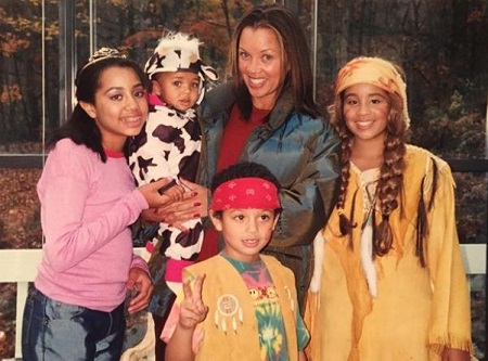 The childhood image of Sasha Gabriella Fox (wearing a black and white dress) with her mother, Vanessa Williams, and half-siblings, Melaine (left), Jillian (right), and Devin Harvey.