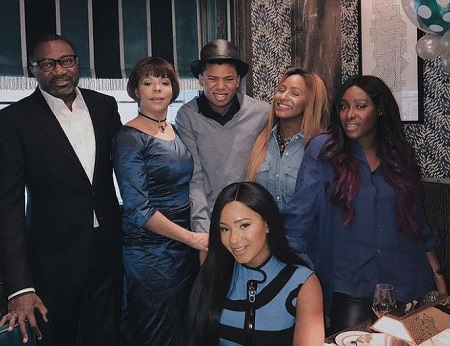Nana Otedola (second from left) and Femi Otedola (left) with their four kids, Tolani (right), DJ Cuppy (second from right), Temi (sitting), and Fewa Otedola.