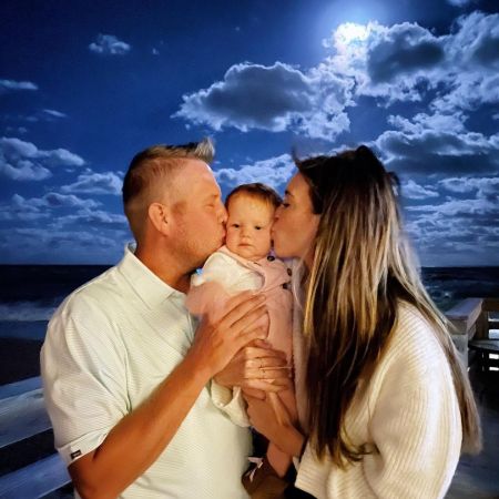 Ann Buck and her second husband, Scott Kitchel kissing their adorable daughter, Evelyn Marie Kitchel. When and where does the duo got hitched?