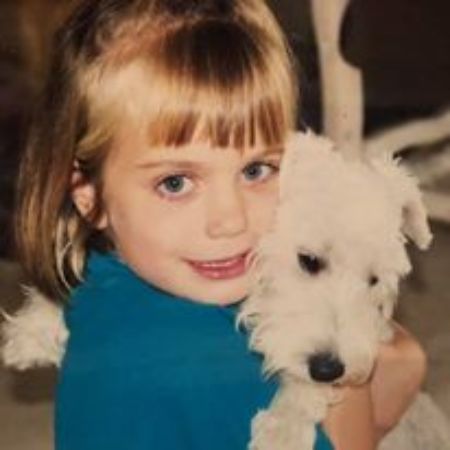 Kristi Krueger hugging her then pet dog when she was a child. Know all the details about Kristi's age, birthday and birth details!