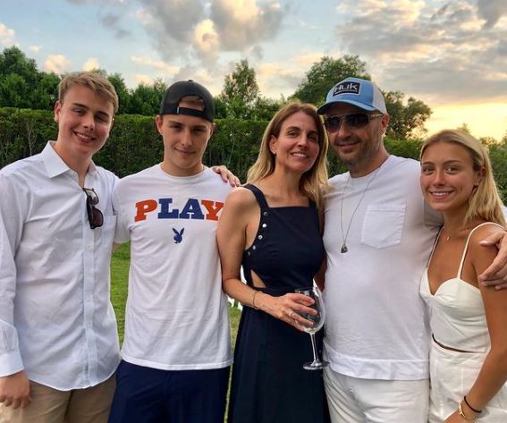  Deanna Bastianich (third from right) with her husband Joe Bastianich (second from right) and three children, Olivia (right), Miles (second from left), and Ethan Bastianich (left). 