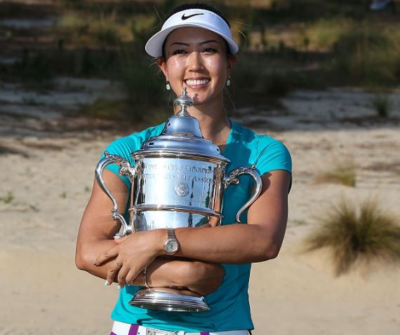 The professional golfer Michelle Wie holds the trophy after her victory during the final round of the 69th U.S. Women's Open