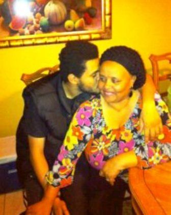 The Weeknd hugging his mother and kissing her cheek.