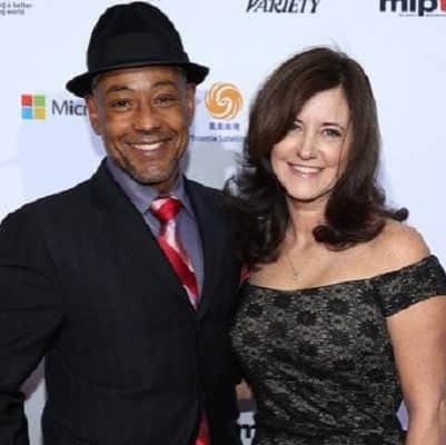 Joy wearing black dress and her husband Giancarlo Esposito wearing black suit with a black hat.