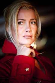 Portrait photo of Romina Di Lella wearing a red coat.