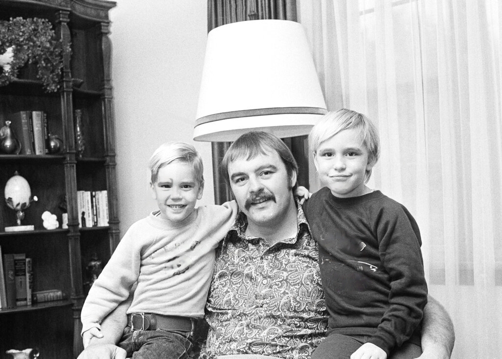 Helen Essenberg's husband, Dick Butkus, and her two sons.