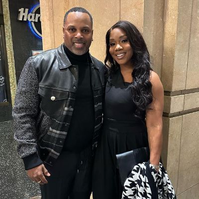 Both Touré Roberts and Sarah Jakes Roberts are posing for the picture in all black as Hard rock café logo can be seen in the background.