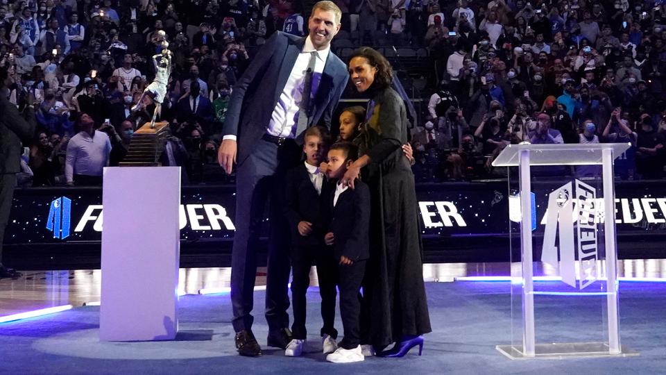 Morris Nowitzki's family posing in a black outfit. 