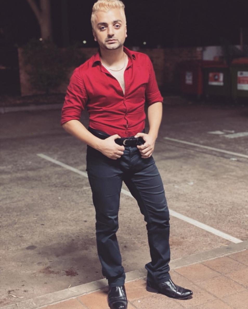 Rahel Romahn posing for photoshoot wearing red short and black pant