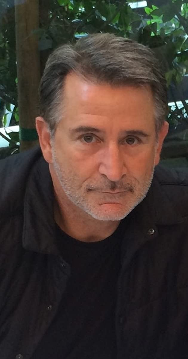 Photo of Anthony LaPaglia wearing a black jacket and a black t-shirt.