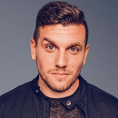 Chris DeStefano posing for a photoshoot  with his one eyebrow up