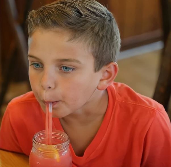 Marco Valastro sucking juice with two straw