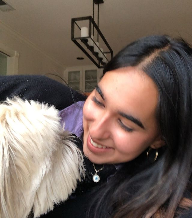 Nikita Mankad posing for a photo with her dog