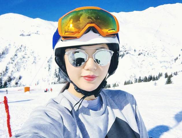 Céline Nha Nguyen wearing sunglass and taking selfie in the middle of the base camp of the mountain