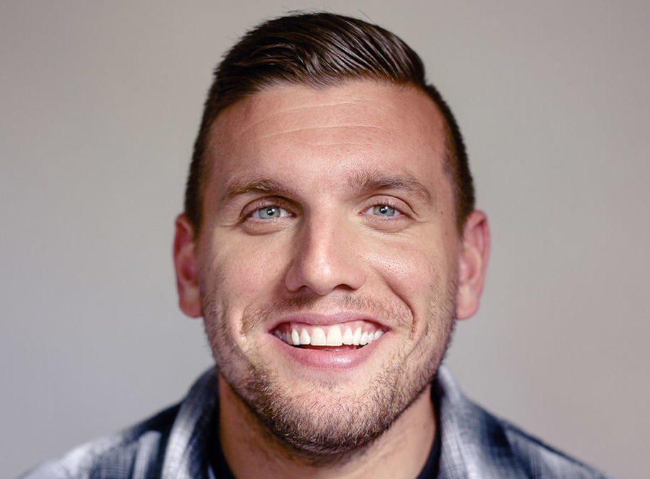Chris DeStefano  captured in a laughing pose with a blue sparling eyes