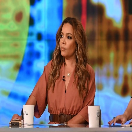 Sunny Hostin was wearing a brown shirt and she has brown hair .
