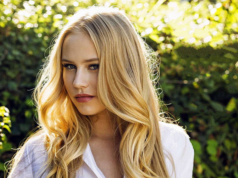 Danika Yarosh posing for the photo with a dark grey hair and a little smile in her face.
