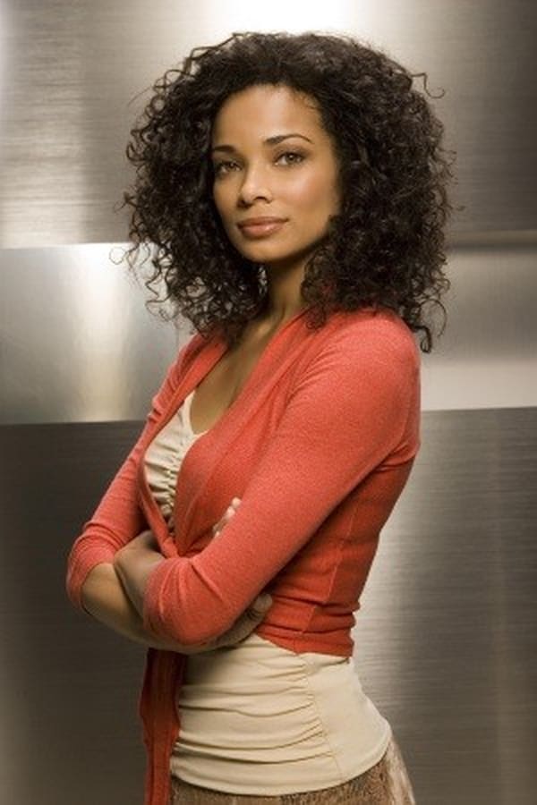 Rochelle Aytes posing for a photo in a black thick curly hair