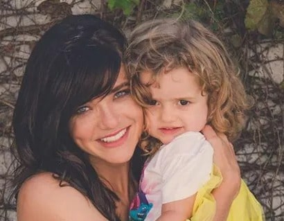 Image of Karen Jonz Holding her Daughter Sky Jonz Silveira.