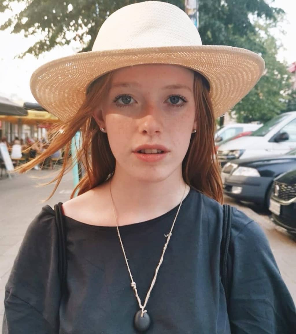 Amybeth McNulty posing for photo wearing hat