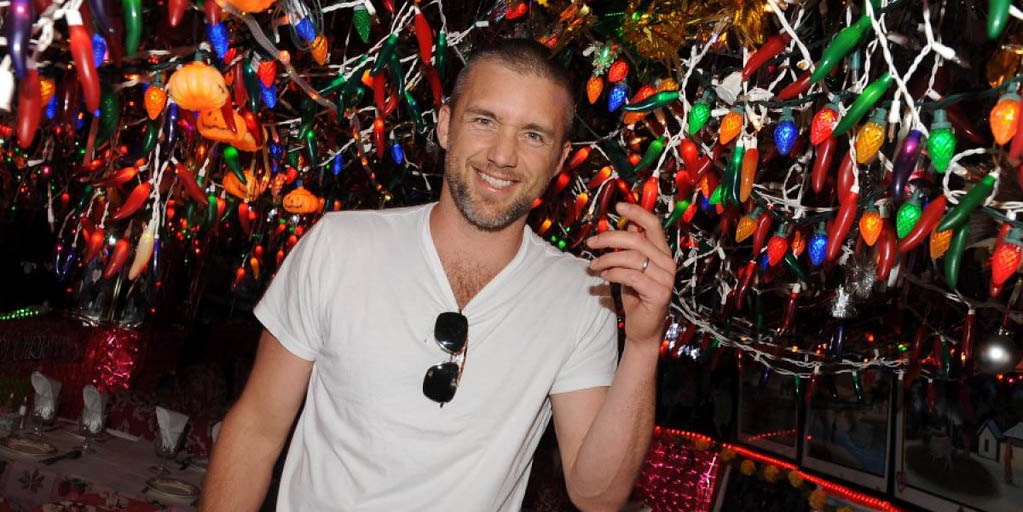 Jeff Hephner posing for the photo wearing  white shirt and colorful background