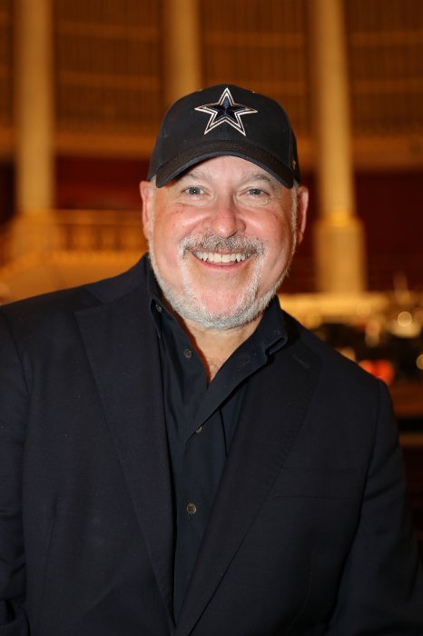 Frank Wildhorn was captured in a smiley face wearing black cap and black shirt