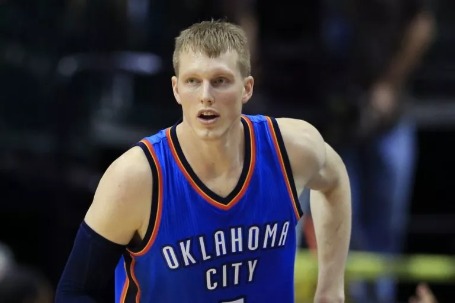 Photo of Kyle Singler during a basketball match by wearing blue jersey.