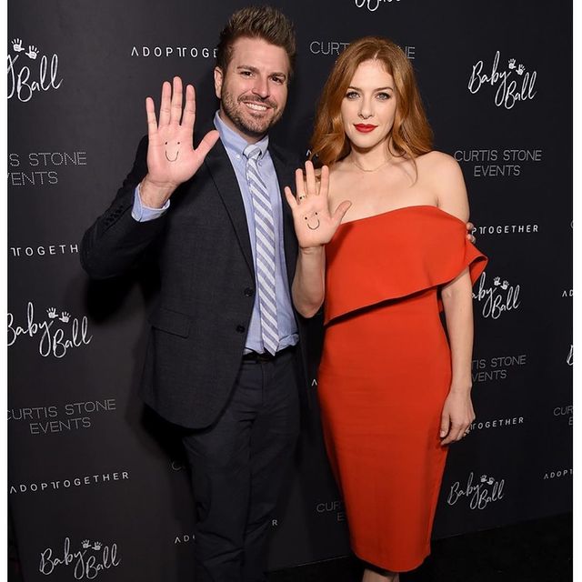 Picture of Rachelle Lefevre with her husband Chris Crary posing for a photoshoot wearing red color gown