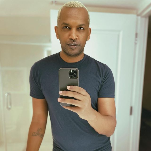 Picture of  Solomon Georgio posing for a photoshoot wearing grey color t shirt