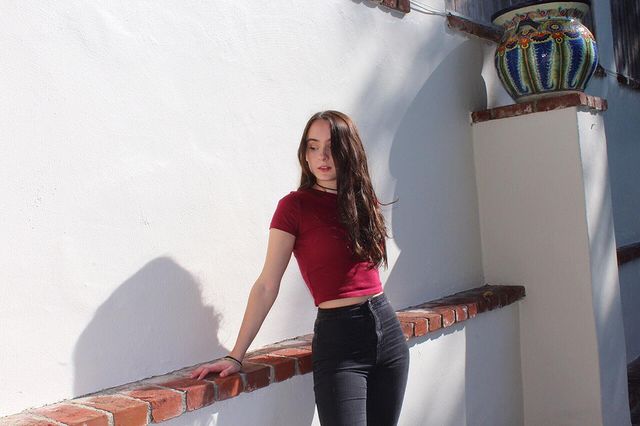 Picture of Rose Lenore Sophia Blake posing for a photoshoot wearing red color t shirt and black color jeans