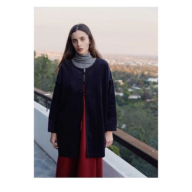 Sonja Kinski posing for a photoshoot for her Instagram feed by wearing long black dress.