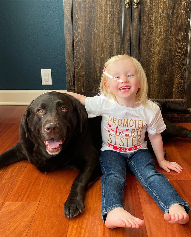 A picture of Brittany Lincicome's daughter, Emery Picture with her pet dog.