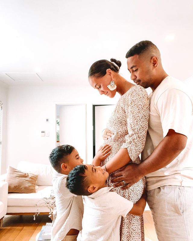 Picture of Beulah Koale with his wife Georgia Otene and twin son posing for a photoshoot wearing white color dress