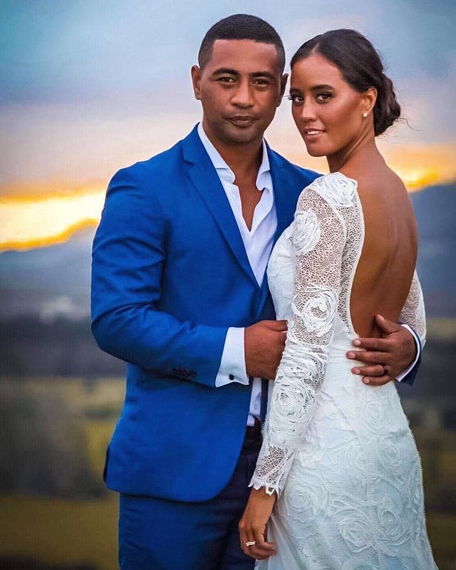 Picture of Beulah Koale with his wife Georgia Otene posing for a photoshoot wearing blue color blazer 