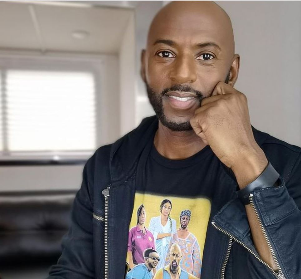 Romany Malco was captured laughing wearing black shirt