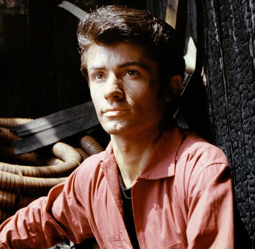 George Chakiris in his young age posing for the picture looking above 