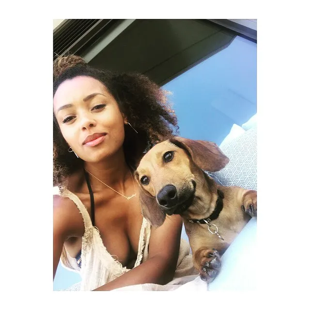 Picture of Melanie Liburd with her pet wearing white color top