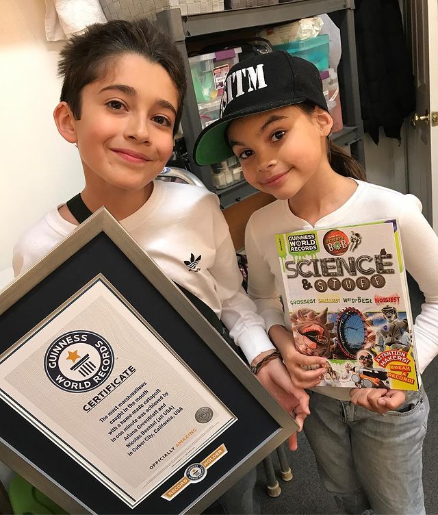 Picture of Nicolas Bechtel and his friend, Ariana Greenblatt holding a Guinness World Record.