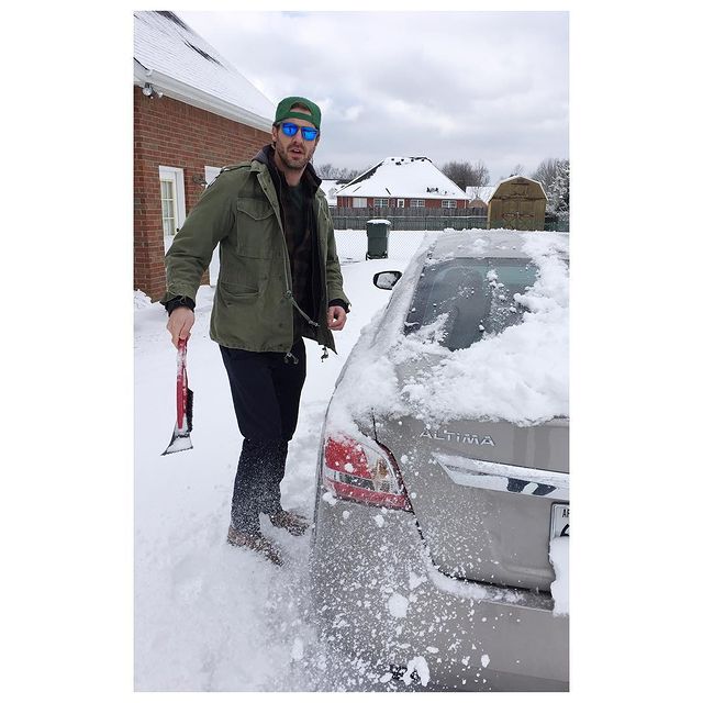 Picture of Tilky Jones and his car in snowy weather.