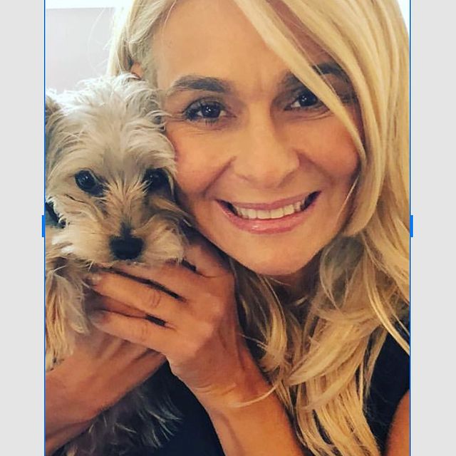 Mary Sciarrone posing for a photo shoot holding her dog.