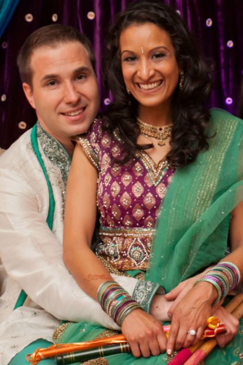 Picture of Aditi Kinkhabwala with her husband Matt Wirginis posing for a photoshoot wearing green and white color dress