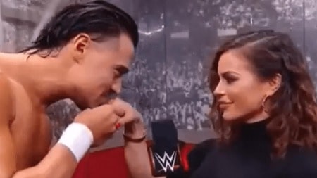Angel Garza kissing Charly Arnolt on  her hand