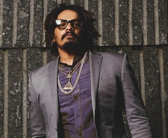 Photo of John Nesta Marley's father Rohan Marley wearing black glasses and chains in the neck