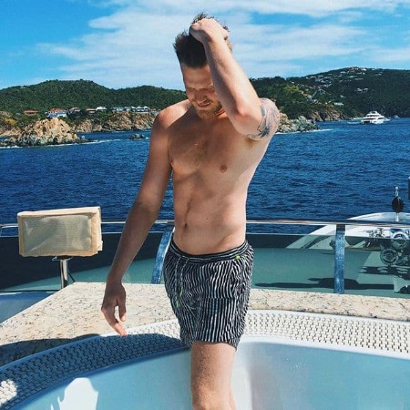 Scott Hoying his six pack abs and bisceps in his boat 