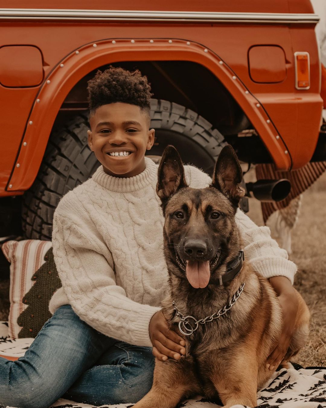 Picture of Brandi Maxiell's son John Maxiell II and her Malinois dog