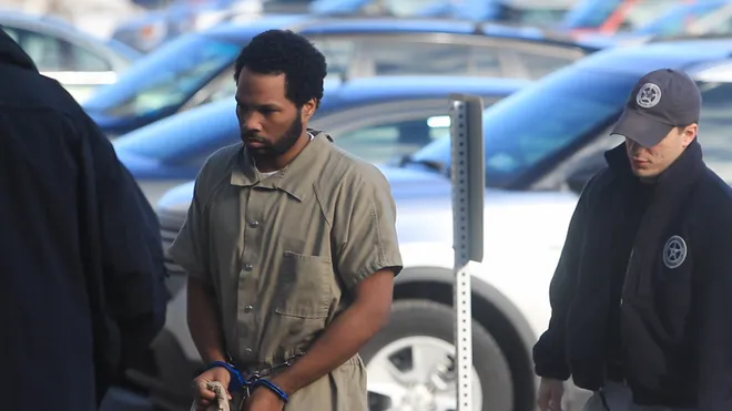 Mendecees Harris wearing handcuffs and on his way to the court of Rochester City with couple of police 