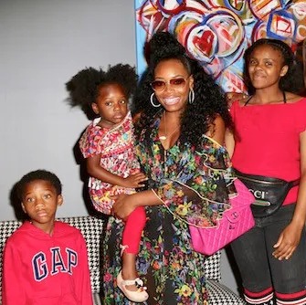 Photo of Yandy Smith with her two biological children Omare and Skyler Smith and her adopted child Infinity Gilyard 