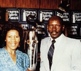 Deloris Jordan in blue clothes and her belated husband James Raymond Jordan in a white attire