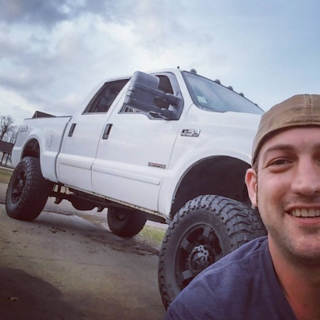 Lyle Boudreaux with his white truck.